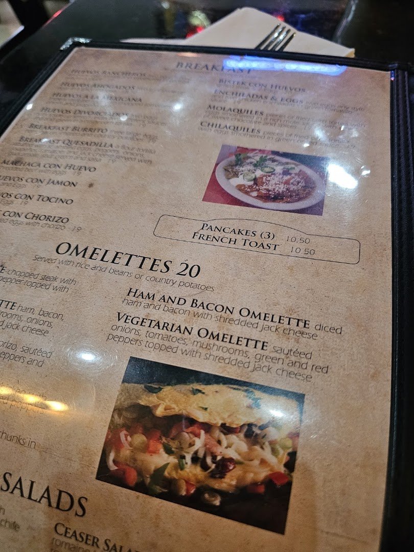 Casual tables and chairs inside a family-friendly restaurant.