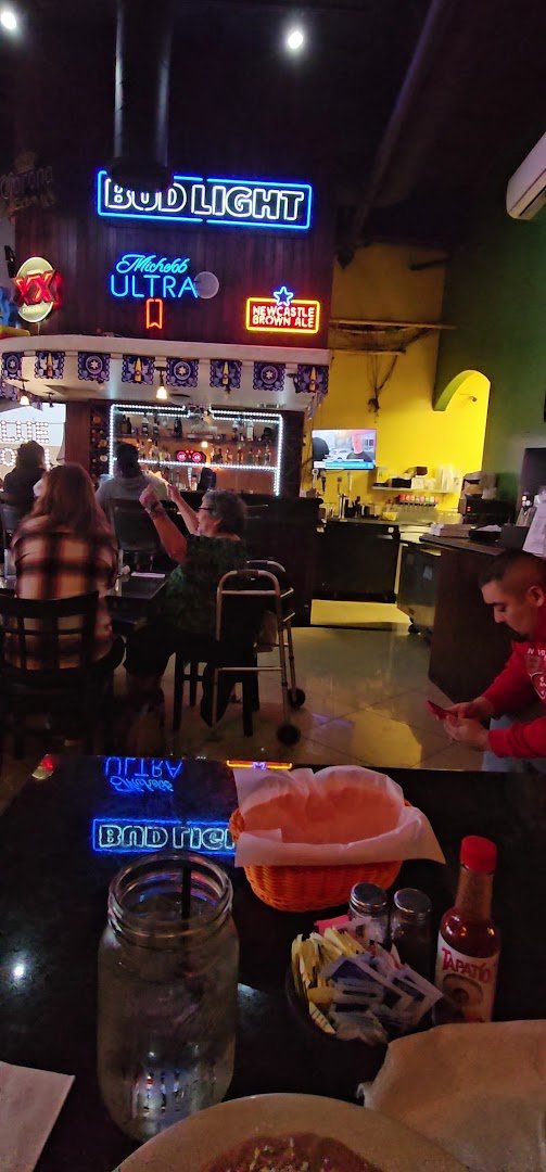 Colorful Mexican restaurant dining room with table service.