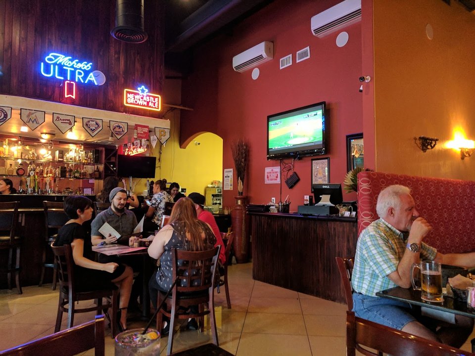 Bar seating beside a cozy dining area.